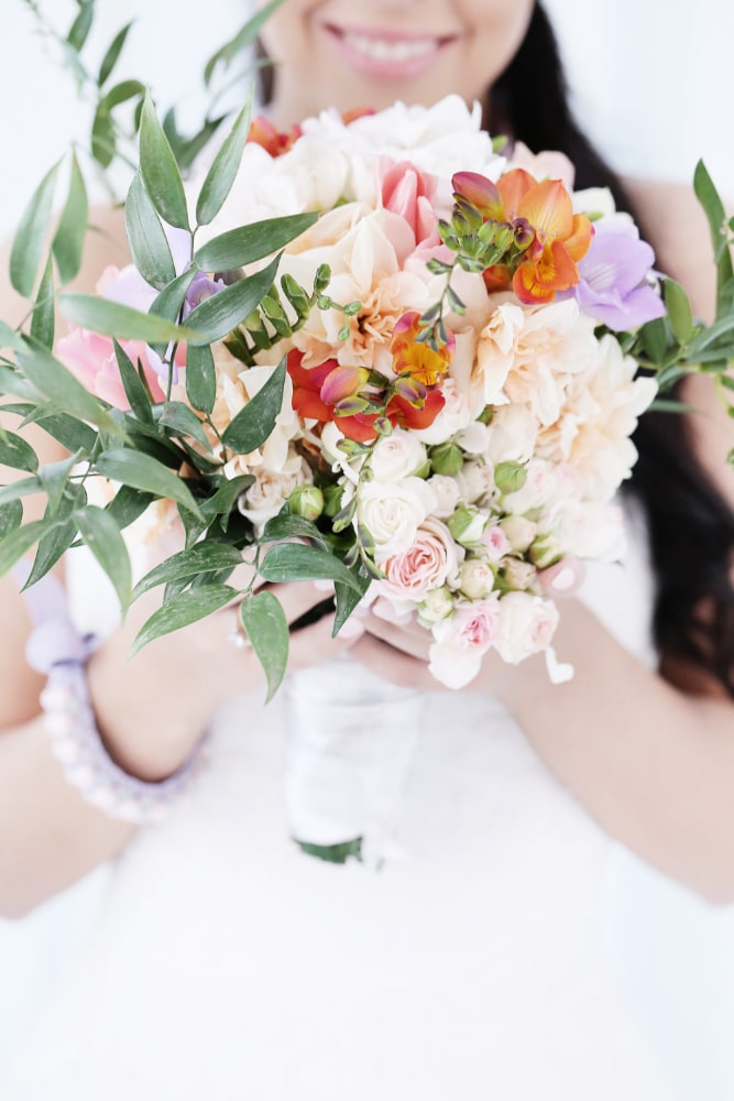 beautiful-bride-woman-wedding-dress-holding-bouquet-flowers