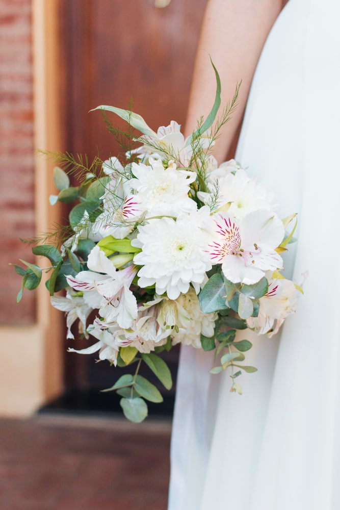 close-up-bride-s-hand-holding-flower-bouquet-hand